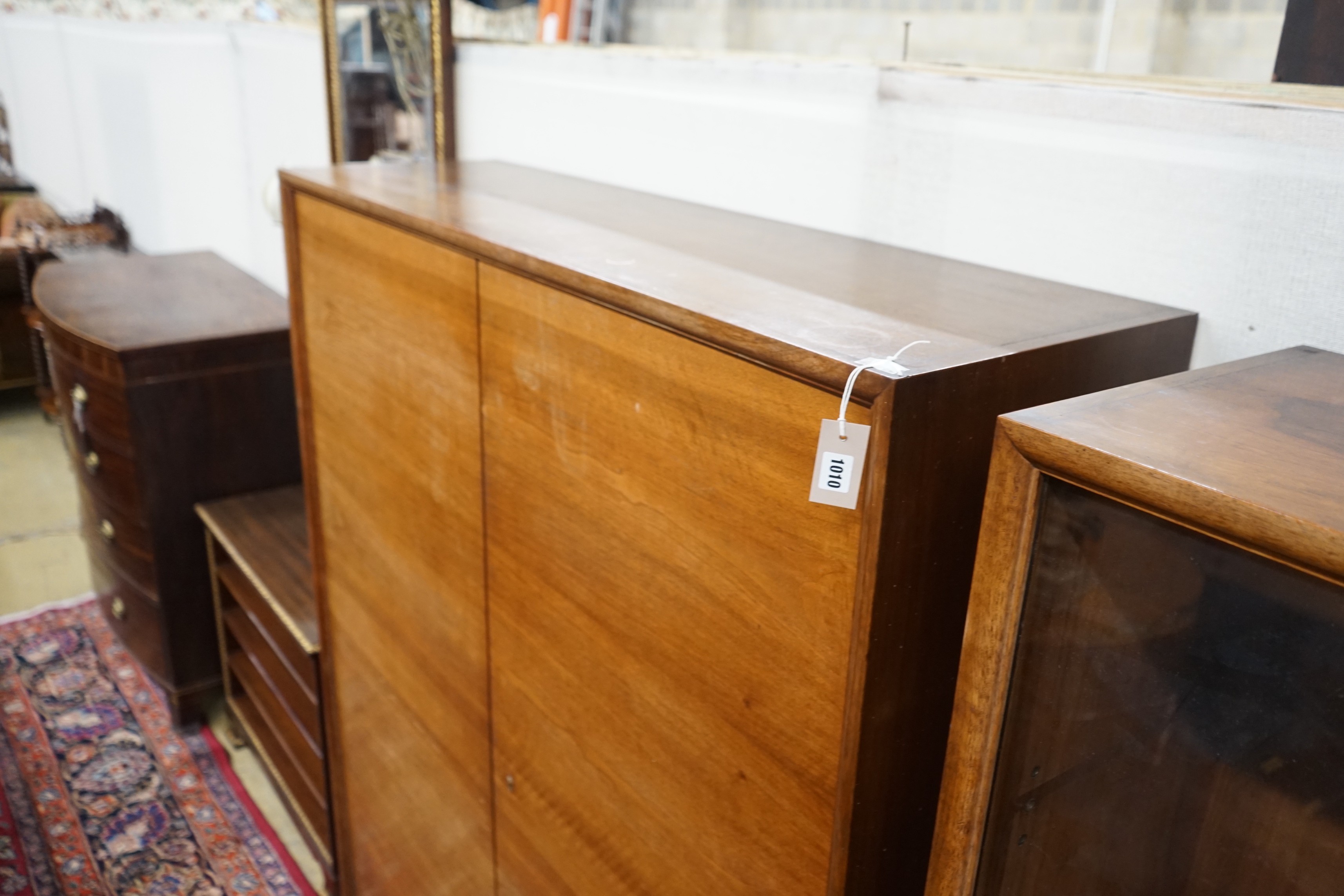 A mid century walnut two door cabinet, by Georg Schoettle, Stuttgart, width 135cm, depth 40cm, height 160cm